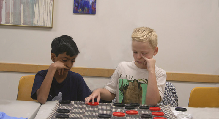 CC boys playing checkers