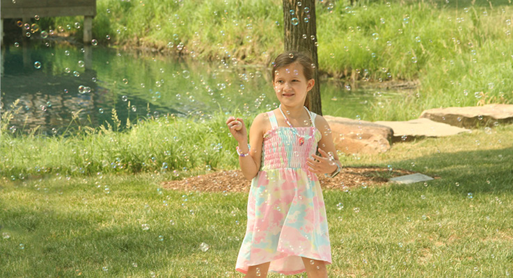 Lakeside park and play girl with bubbles 2